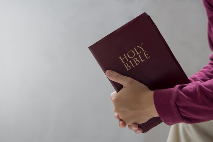 Bible concept.Man reading bible and praying to god before work.